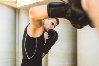 Dışarıda egzersiz yapan ve kavga eden iki adam. Eldivenli boksör antrenman yapıyor.