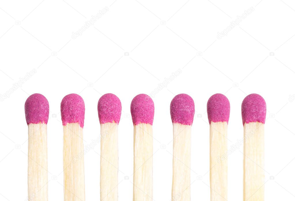 Close-up view of matchsticks lined in a row against white background.