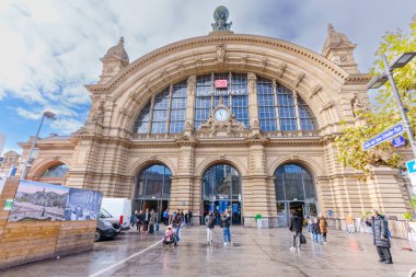 Frankfurt, Germany - October 21, 2025: Architectural detailing of Frankfurt's main railway station, a Neo-Renaissance marvel, displaying its grand entrance, clock, and pedestrian flow.