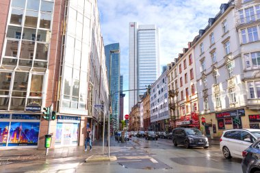 Frankfurt, Germany - October 21, 2025: Dynamic urban panorama of Frankfurt, highlighting contemporary skyscrapers alongside traditional residential structures under a partly cloudy sky.