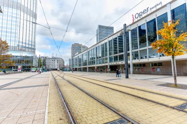 Frankfurt, Germany - October 21, 2025: Opernplatz in Frankfurt, Germany, presents a dynamic urban vista, featuring the modern Opera building, towering skyscrapers, and intricate tramway infrastructure