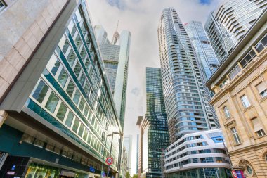 Frankfurt, Germany - October 21, 2025: Frankfurt's financial district showcases an array of contemporary glass skyscrapers and modern office buildings on a bright urban day.
