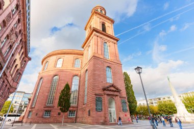 Frankfurt, Almanya - 21 Ekim 2025: St. Paul Kilisesi, tarihi bir kırmızı kumtaşı binası, Frankfurt şehir meydanında dağınık mavi bulutların altında belirgin bir şekilde duruyor..