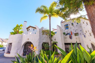 Beyaz sıva, renkli mozaik detaylar ve berrak mavi gökyüzünün altında canlı bir cennet kuşu olan seçici Santa Barbara binasının görüntüsü..