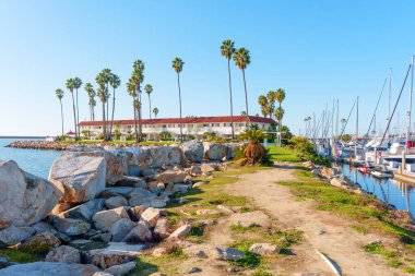 Oceanside, California - 28 Aralık 2025: İspanyol tarzı mimarisi ve bereketli palmiye ağaçları olan şık sahil beldesi, güneşli Oceanside, Kaliforniya 'da sakin deniz manzarası sunuyor..