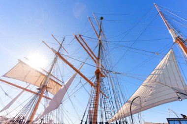 San Diego, California - 30 Aralık 2025: Görkemli gemi direkleri ve beyaz yelkenler açık mavi gökyüzüne karşı San Diego Denizcilik Müzesi 'nde parlak bir güneş ışığı altında.