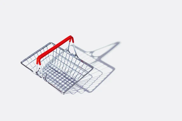 Cesta de compras de metal vacía sobre fondo gris. — Foto de Stock