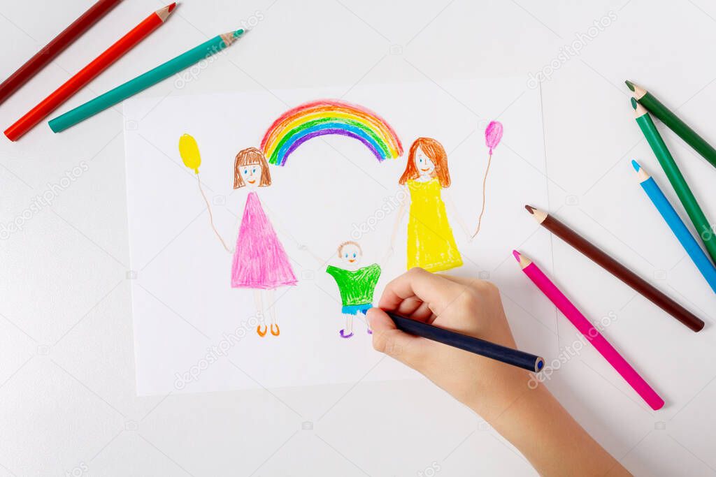Child drawing his LGBT family. Top view. 