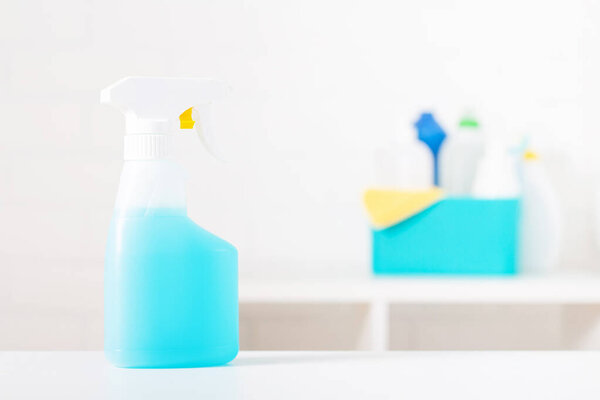 Blue disinfectant spray. Cleaning supplies. Hygiene concept. 