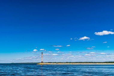The view on the lighthouse and cloudy sky