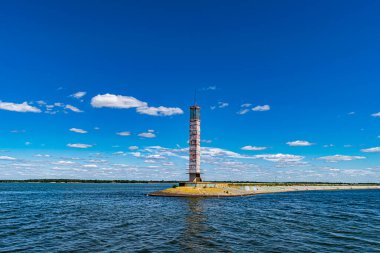 The view on the lighthouse and cloudy sky