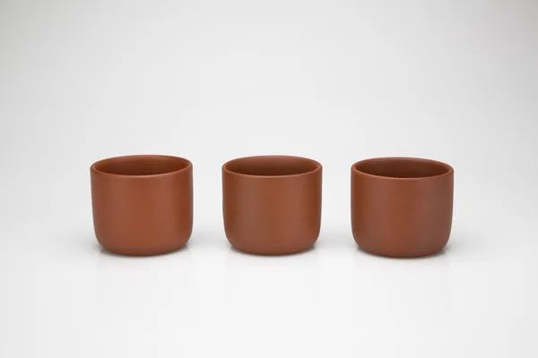 Three clay cups in a row — Stock Photo, Image
