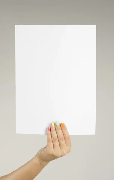 Female hand holding a blank sheet of paper — Stock Photo, Image