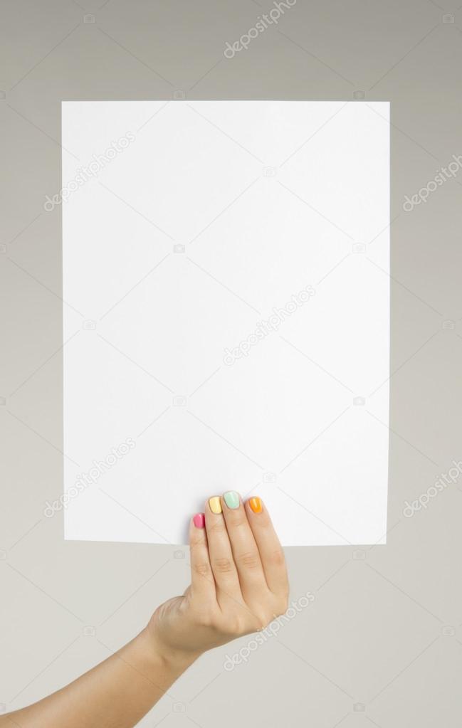 Female hand holding a blank sheet of paper