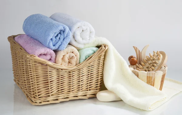 Set of rolled towels and bath accessories — Stock Photo, Image