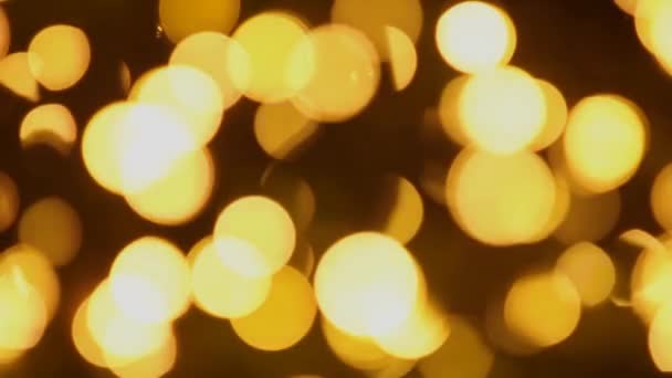 Flickering bokeh of golden glitter lights. Christmas background. New year party. — Stock Video