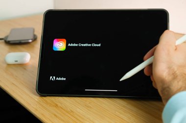 Adobe Creative Cloud iPad Pro tabletinde elmalı kalemle kullanılır. Tabletteki uygulamayı kullanan adam. Aralık 2020, San Francisco, ABD