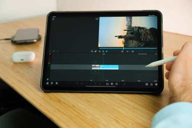 LumaFusion, iPad Pro tabletinde elmalı kalemle kullanılır. Tabletteki uygulamayı kullanan adam. Aralık 2020, San Francisco, ABD.
