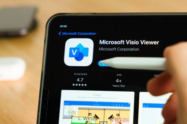 Microsoft Visio Viewer logo shown by apple pencil on the iPad Pro tablet screen. Man using application on the tablet. December 2020, San Francisco, USA.