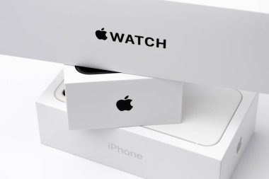 Apple watch, black and white iPhone boxes on the white background, December 2020, San Francisco, USA