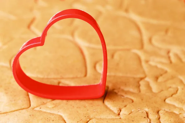 Heart shaped baking mold for making gingerbread cookies on the dough. St. Valentines sweets