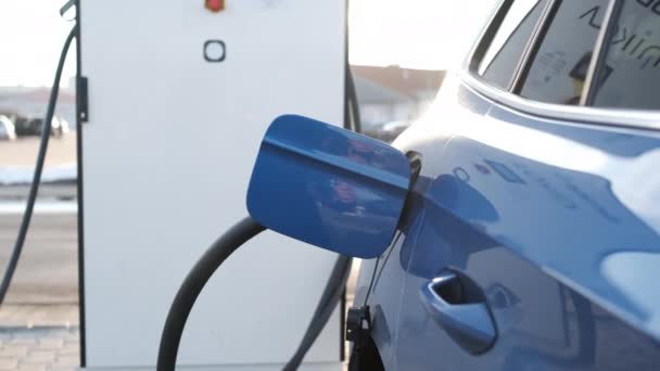 Carga de coche eléctrico azul en una estación de carga en la calle. — Vídeos de Stock