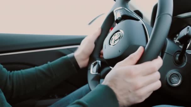 Man driving new Skoda auto. Driving a car. Mans hand on the wheel. Rental car concept, March 2021, Prague, Czech Republic — Stock Video