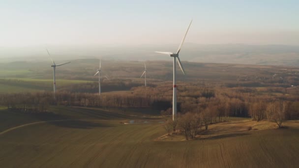 Panoramautsikt över en gård med vindkraftverk vid solnedgången. Vindkraftverk som alstrar elektricitet. — Stockvideo