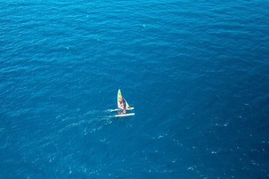 Aerial view of portable sailboat windsurfing catamaran in blue water of Adriatic Sea clipart