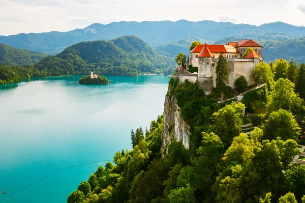 슬로베니아에 있는 청록색 물로 둘러싸인 블 레드 호수 밑 산의 절벽에 있는 중세 시대의 블 레드 성을 공중에서 내려다본 모습 — 스톡 사진