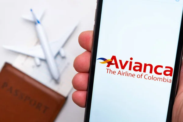 Logotipo de la aerolínea Avianca en la pantalla del smartphone en el fondo del pasaporte, billete y avión, septiembre 2021, San Francisco, EE.UU. — Foto de Stock
