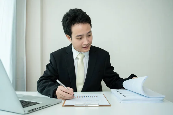 Asian Young Businessman Making Online Video Conference While Working Home Stock Photo