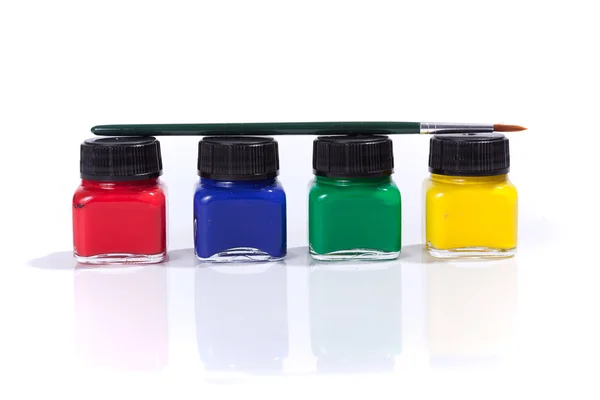 Four paint bottles in prime colors — Stock Photo, Image