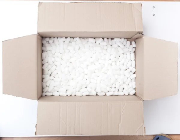 Packaging box filled with styrofoam pellets — Stock Photo, Image