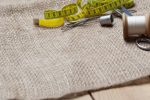 Needlework tools on jute cloth — Stock Photo, Image