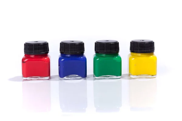 Four paint bottles in prime colors — Stock Photo, Image