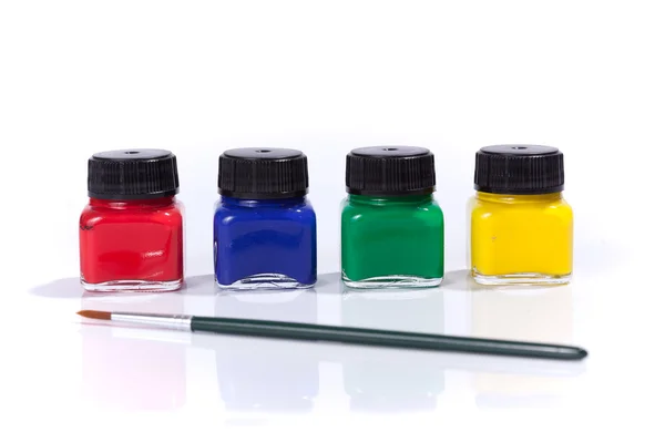 Four paint bottles in prime colors — Stock Photo, Image