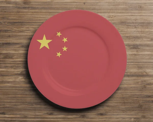 Plate on table with China flag — Stock Photo, Image