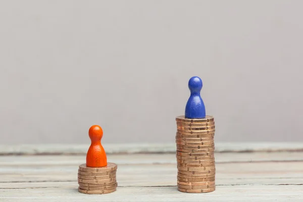 Wealth concept, red and blue pawn on coin stacks — Stock Photo, Image