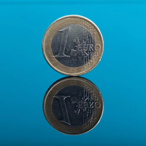 One Euro money coin on blue with reflection — Stock Photo, Image