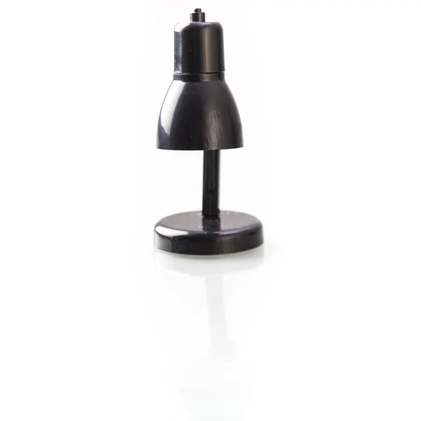 Miniature black lamp on white table — Stock Photo, Image