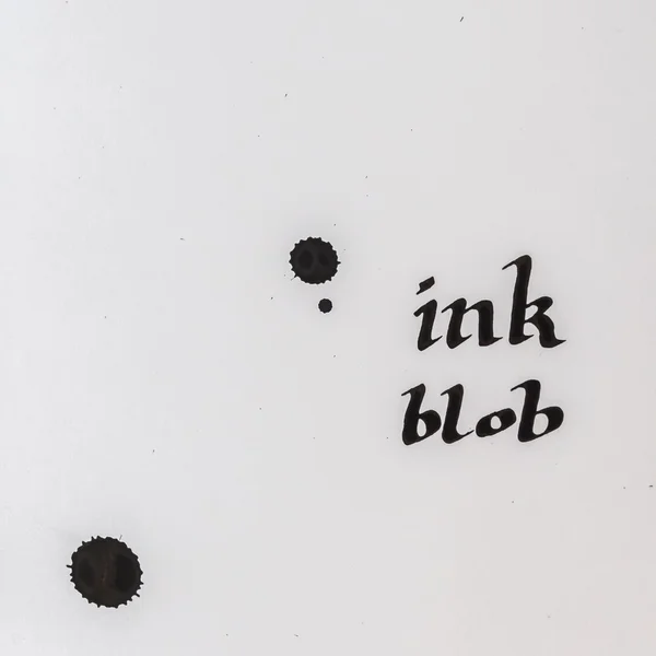 Splashes of ink and handwriting words on white paper — Stock Photo, Image