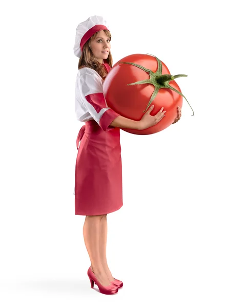 Cozinheiro chef menina segurando um tomate grande — Fotografia de Stock