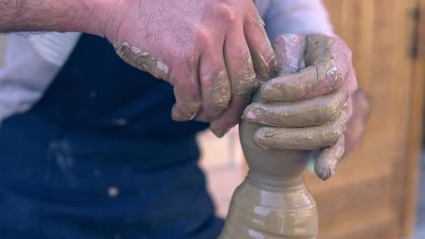 Closeup of potter making clay vase on mechanical pottery wheel — Stock Video