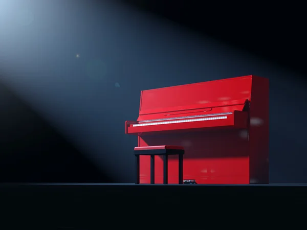 Красное пианино на сцене — стоковое фото