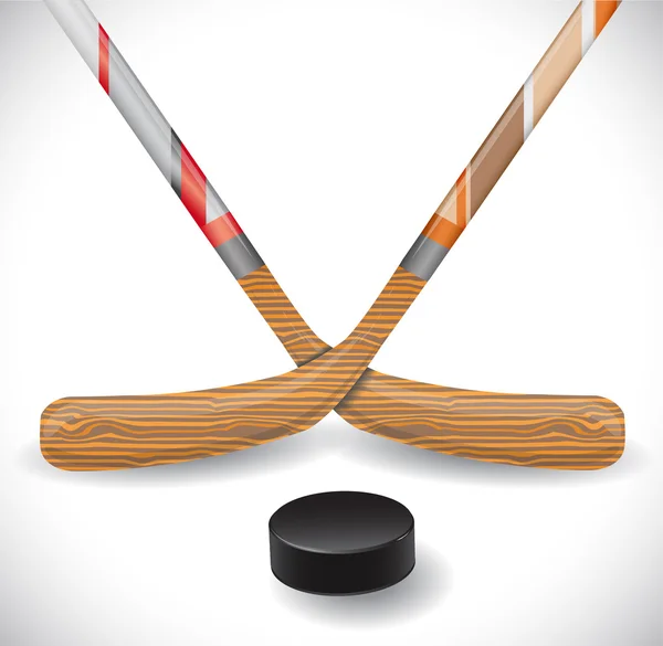 Bâtons et rondelle de hockey . — Image vectorielle