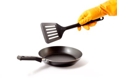 Gloves  with a kitchen spatula. clipart