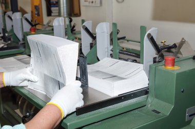 Binding of books in printing house clipart
