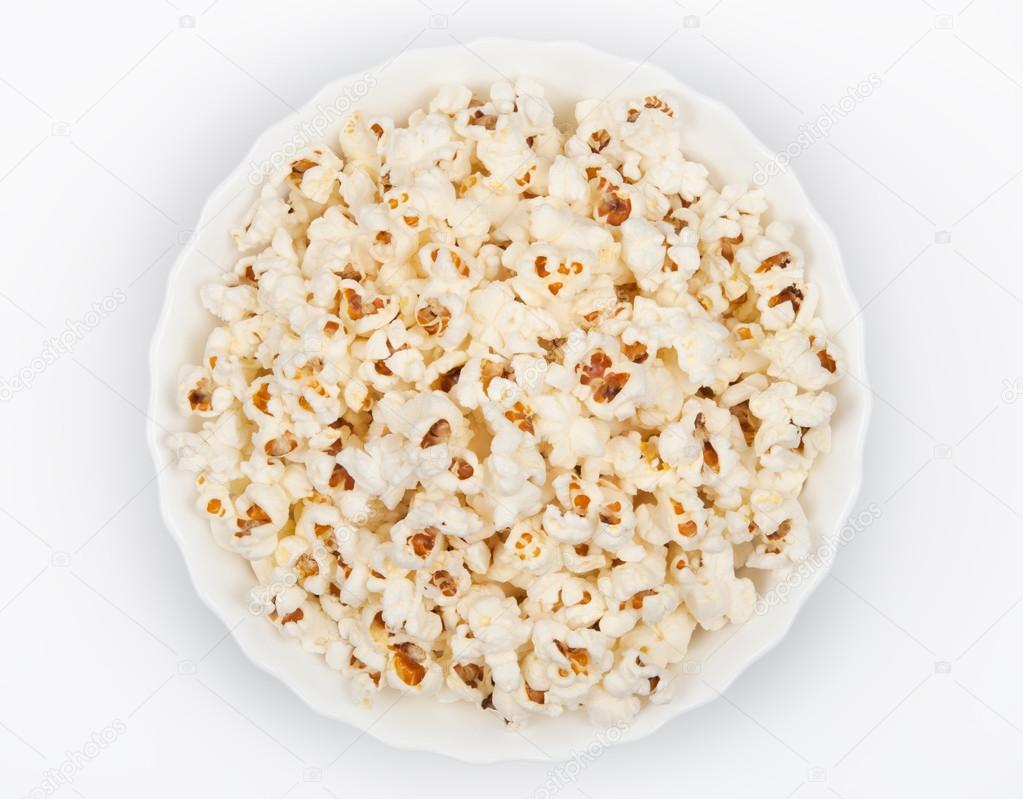 Bowl of popcorn on grey background. Top view