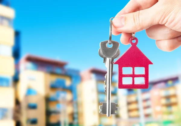 Handing keys in the house background — Stock Photo, Image
